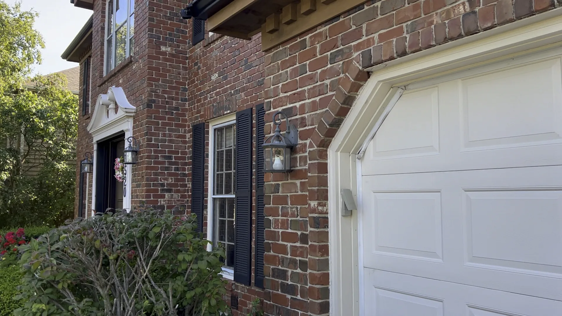 Brick house exterior lights before replacement near garage and front entry in Chicago Handyman Services in Chicago