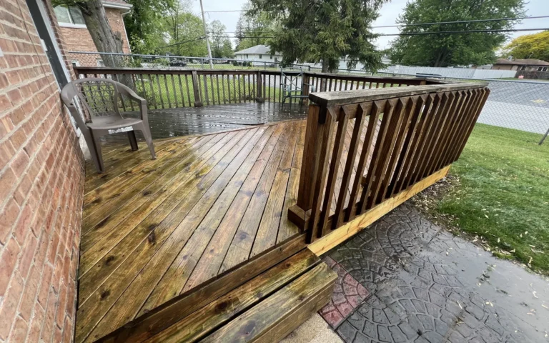 Cleaned and stained wooden deck with railings and steps