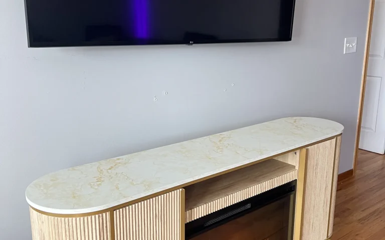 Modern curved TV stand with marble top and built in electric fireplace