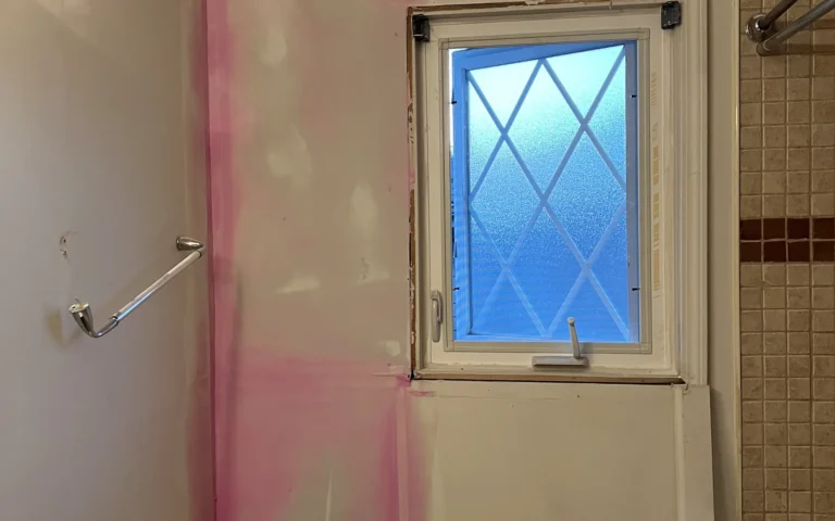 Bathroom renovation with pink walls new window and drywall repair work
