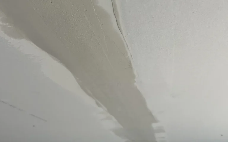 Ceiling crack repair showing patched drywall seam and texture