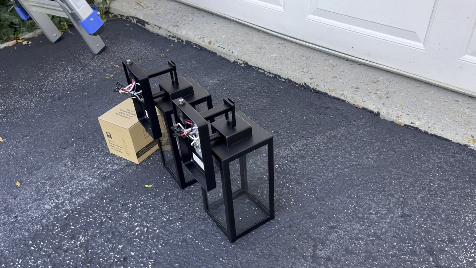 New black outdoor wall light fixtures prepared before installation in Chicago Handyman Services in Chicago