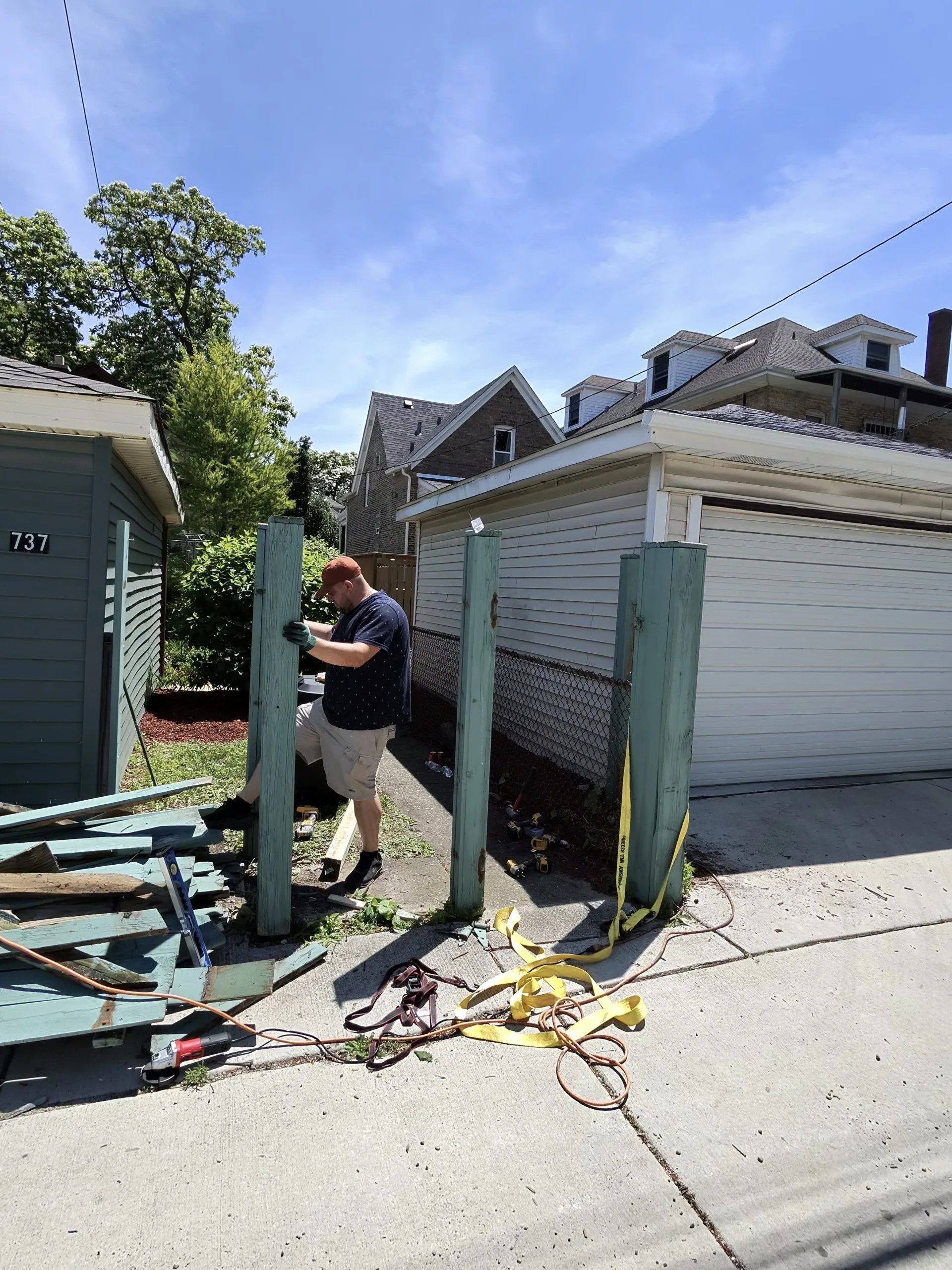 Old wood fence panels removed during fence repair project in Chicago