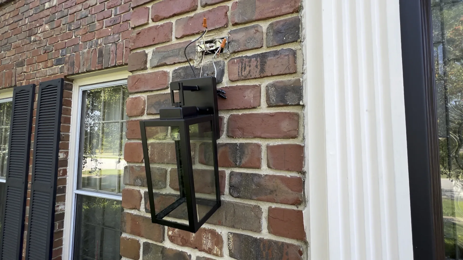 Outdoor wall light installation on brick with existing wires exposed in Chicago Handyman Services in Chicago