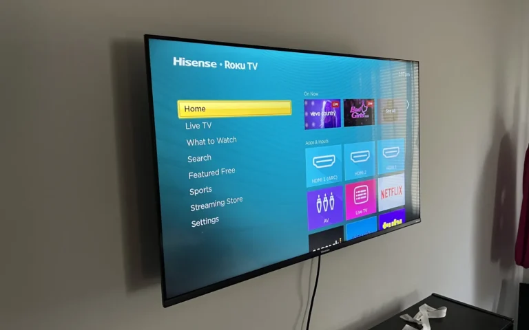 Mounted Hisense Roku TV displaying home screen menu on wall