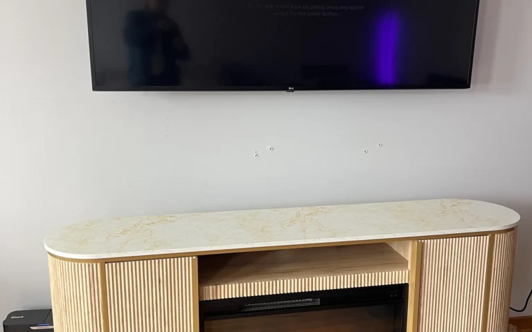 Modern media console with electric fireplace and wall mounted TV in living room